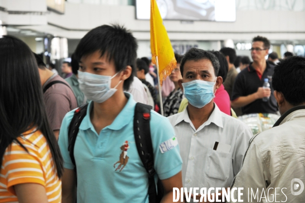 Grippe porcine, voyageurs masqués en Chine