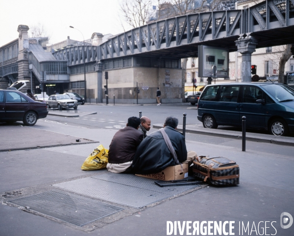 Paris, Hommes assis sur une bouche d air du métro