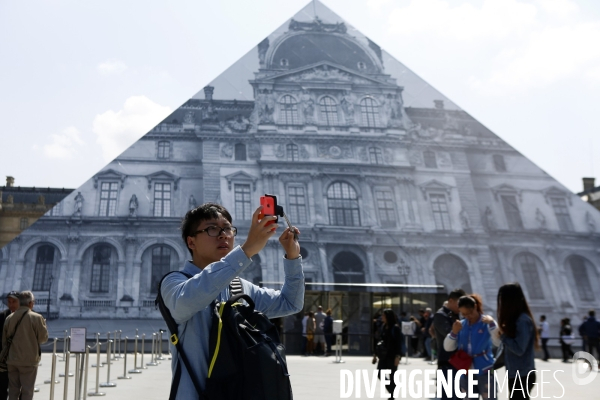 L artiste JR décore la pyramide du Louvre