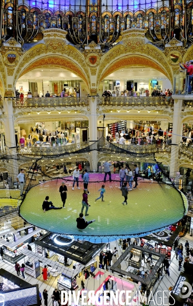 Un trampoline suspendu sous la verriere des Galeries Lafayette