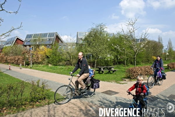 Eva Lanxmeer, un éco quartier a Culemborg, aux Pays Bas.Une famille a velo a la sorite de l ecole