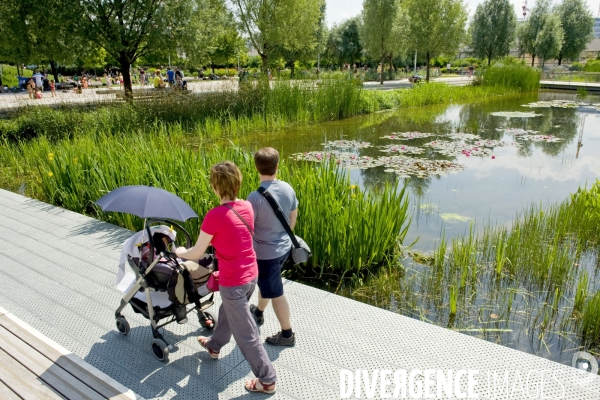 Illustration Juin 2014.Un jeune couple promene son bebe en poussette au  parc Martin Luther King dans la zac Clichy Batignolles.